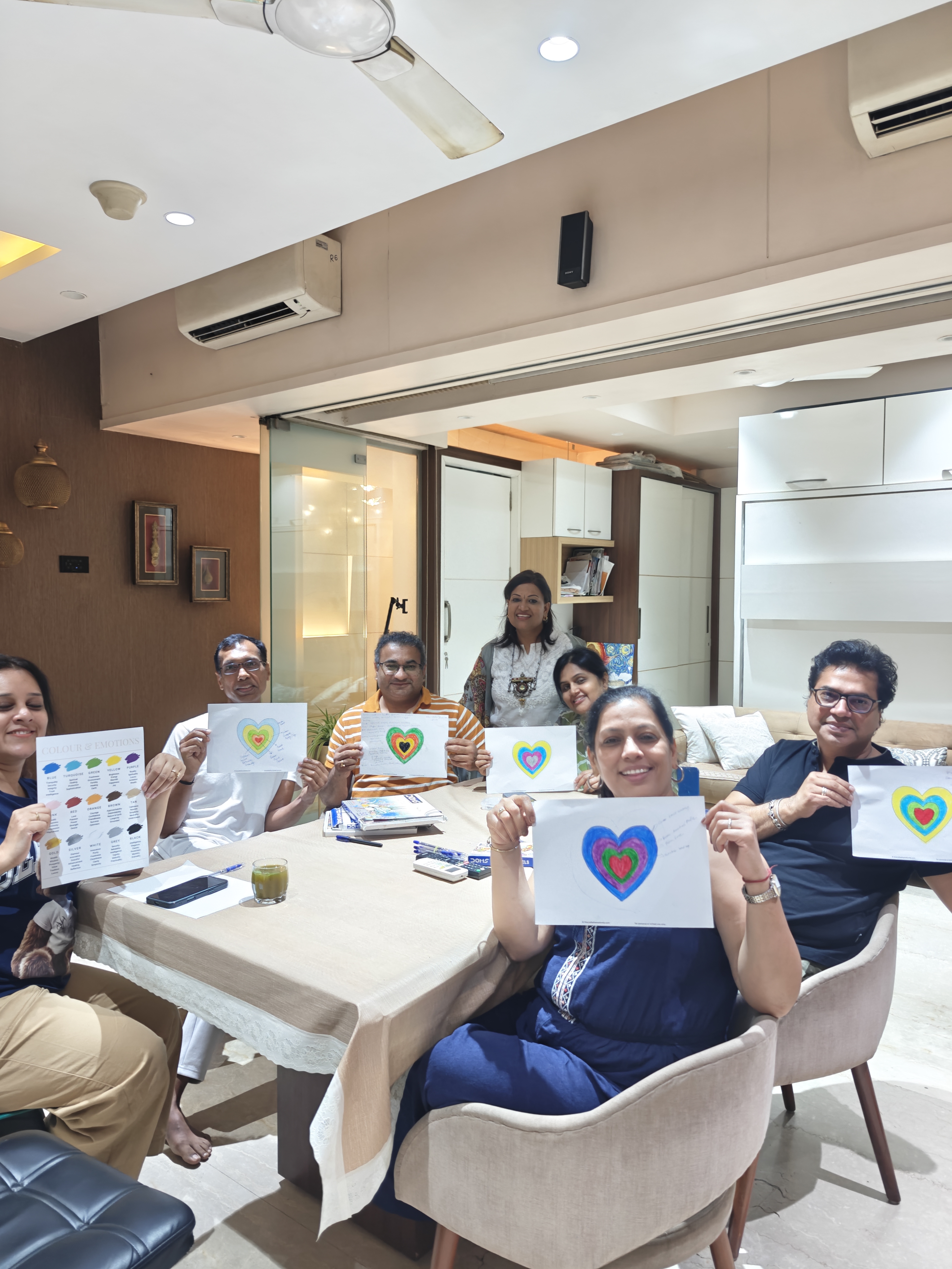 Workshop participants holding heart paintings