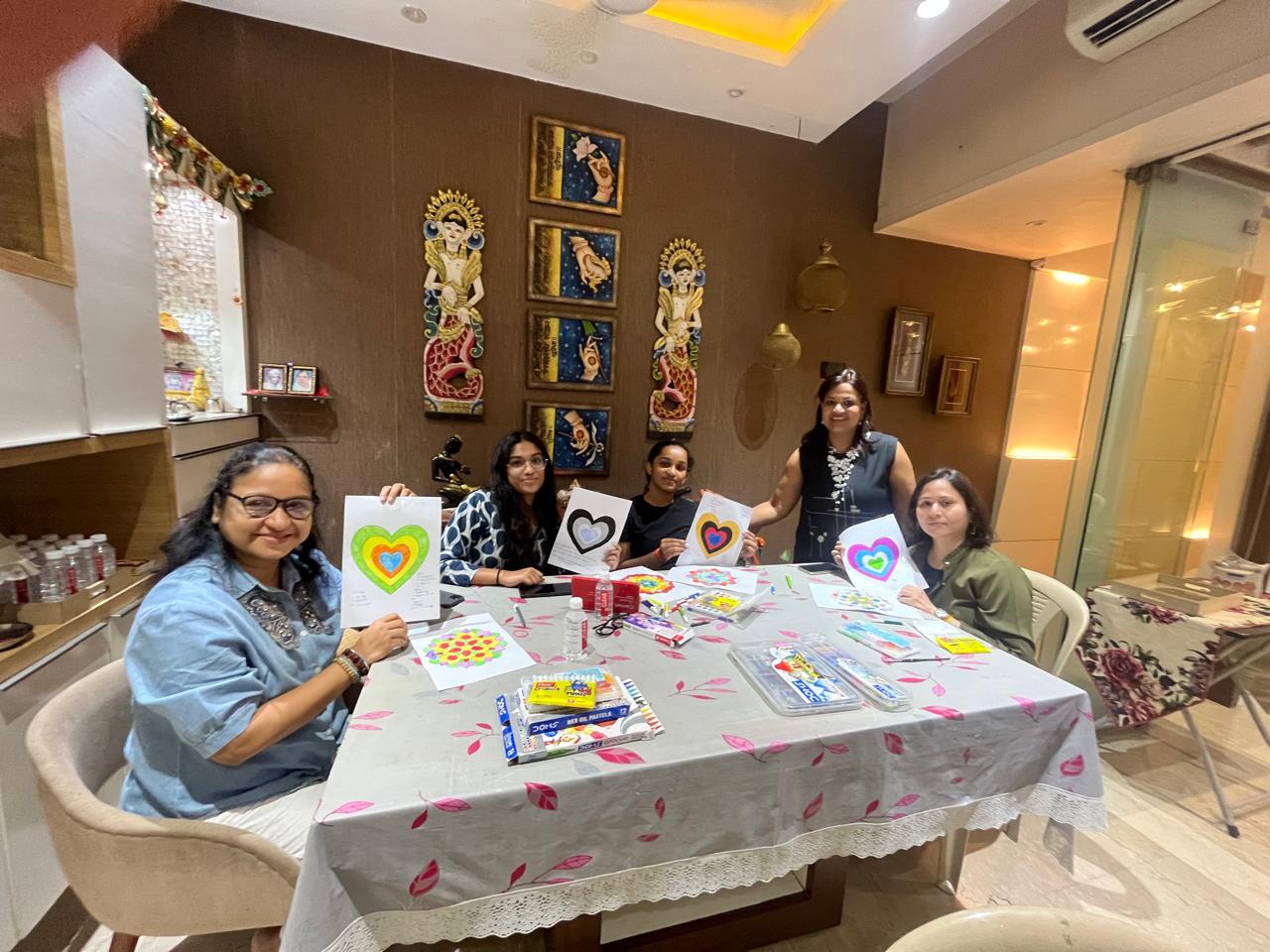 Group of women holding their artwork